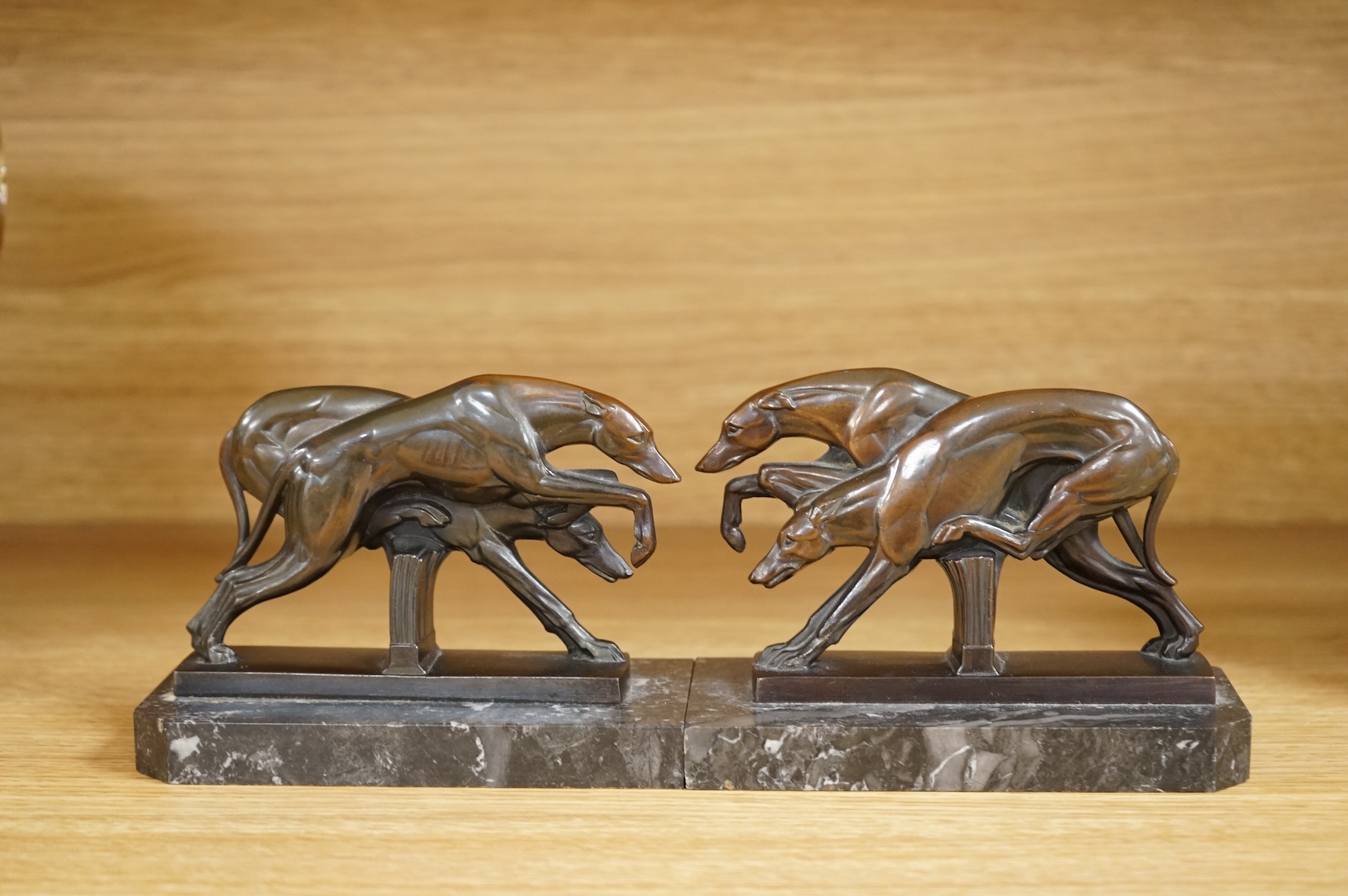 A pair of French Art Deco spelter bookends in the form of racing greyhounds, 14.5cm wide